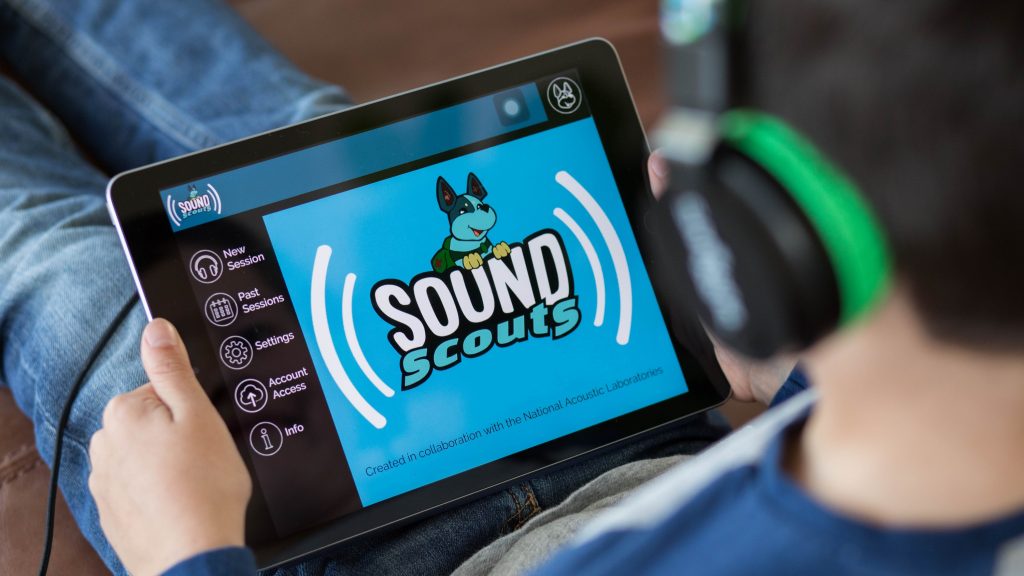 A child plays Sound Scouts on a touch screen device