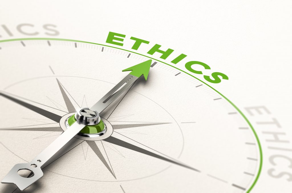 stock image of a compass with needle pointing to ethics