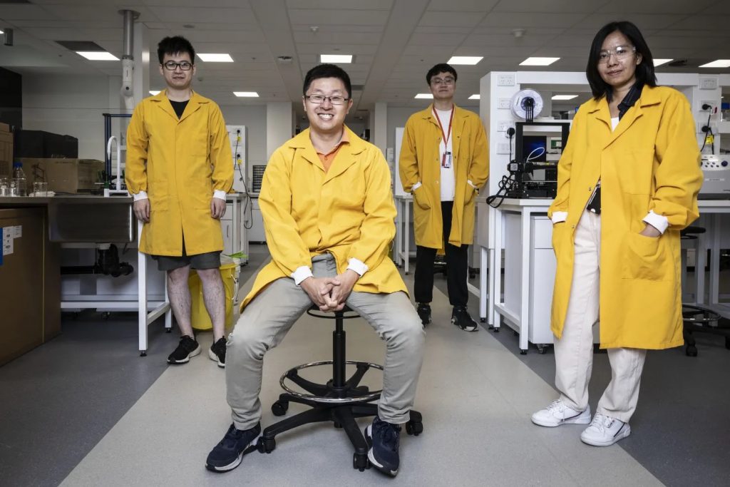 Associate professor Arnold Lining Ju with his team in the lab