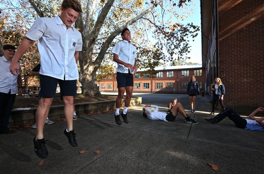 Boys jumping in school ground, exercising in HIIT